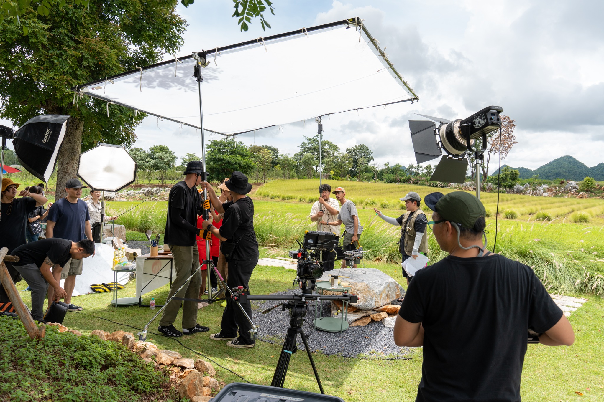 Porjai production crew setting up a shoot outdoors
